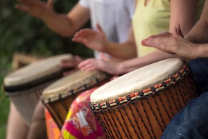 Group,Of,People,Playing,At,Djembe,Drums,Outdoor